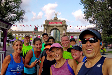 A group of Running Rats pose for a selfie in front of the Princes' Gates at Exhibition Place
