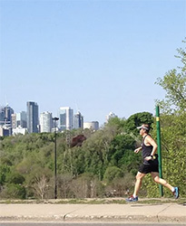 Mike running south on Broadview Avenue, with the skyline behind him